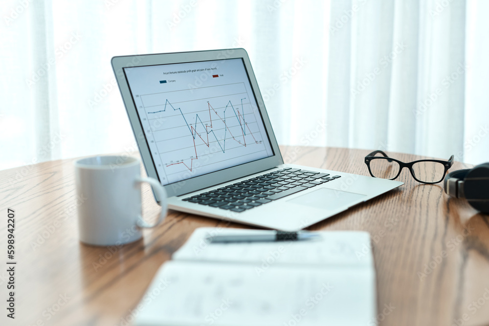 Poster stats speak the loudest. empty shot of a laptop and notebook on a table at home.