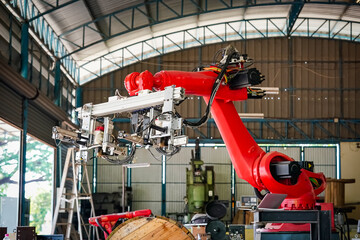 Male technician programs a robot arm with a digital tablet and assembly robot in a factory. Apprentice engineers programming robots in factory.
