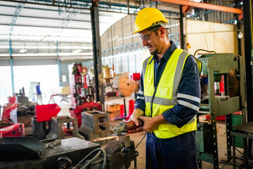Lathe Operators Concentrated on Work. Worker in uniform and helmet works on lathe, factory. Industrial production, metalwork engineering, manufacturing.