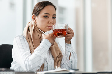 Honey and tea is the perfect remedy for me. a young businesswoman having a glass of herbal tea at her desk in a modern office.