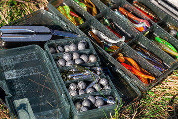 Fishing tackles and fishing baits in box .Classic Colored Fishing Lure , Beautiful Background...