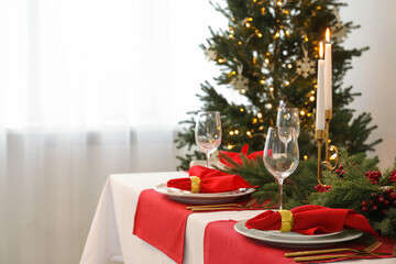 Beautiful table setting with Christmas decor in room, space for text