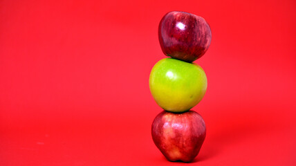Fresh green and Fresh green and red apples isolated on red background. Healthy fruit and vegetable concept.red apples isolated on red background.