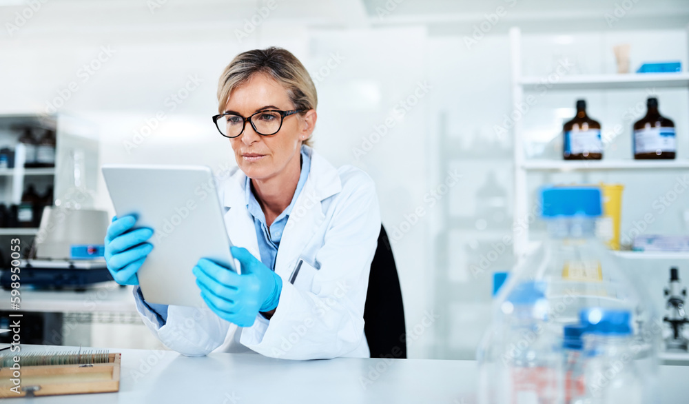 Poster detailing the process of her experiments. a mature scientist using a digital tablet in a lab.