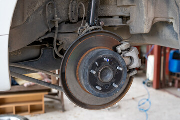 Car front disc break being checked and inspected for safety