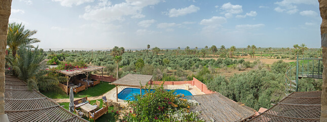 Panoramic view over remote african farmland with swimming pool