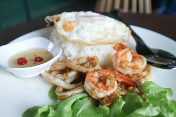 stir fried seafood , stir fried squid or Stir fried shrimp with rice and sunny side up egg