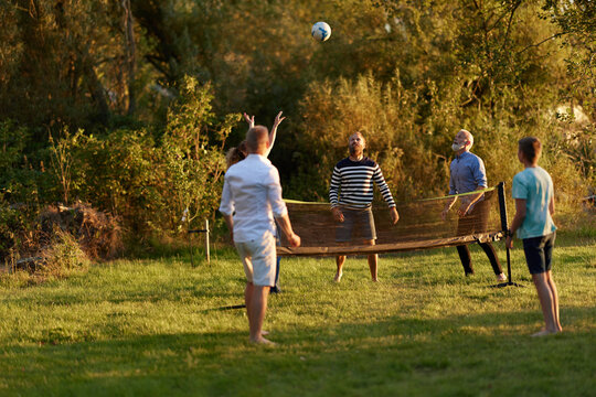 Family playing volleyball outside