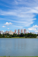 Fototapeta na wymiar Cityscape with a lake and blue sky