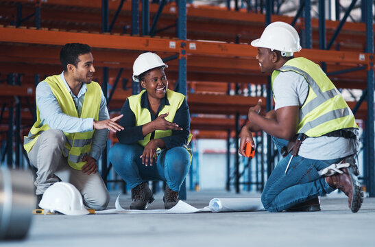 What would you suggest. a group of contractors crouching down in the warehouse together and using a blueprint to plan.