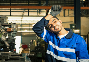 Portraits of workers, technicians, professional engineers, hats, tired from the stress of the hot summer weather, on the production line.