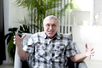 Portrait of Funny retired man with denture looking at the camera and smiling	