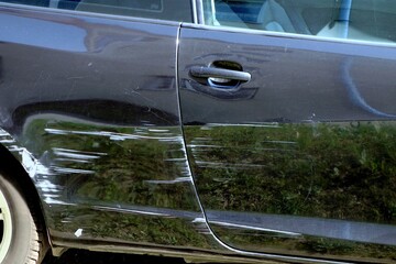 A fragment of a car with a damaged body after a collision