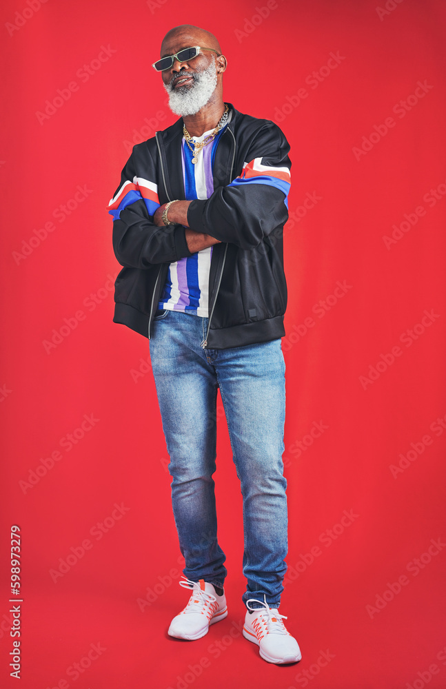 Poster Your style is what makes you unique. Studio shot of a senior man wearing retro attire while posing against a red background.