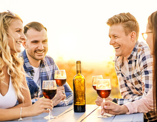 Young friends having fun outdoors - Happy people enjoying harvest time together at farmhouse winery countryside - Youth and friendship concept - Tasting red wine at vineyard before sunset