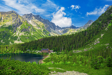 Fototapeta na wymiar Picturesque panoramic view of Popradske Pleso, Tatra mountains, Slovakia. Lake Popradske pleso with mountain hotel in High Tatras.