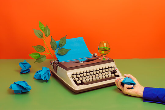 Crop writer with crumpled papers and typewriter over colorful surface