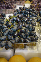 Fresh Black Grapes sold in a plastic box in street market