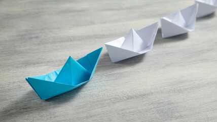 Blue and white paper boats. Business concept
