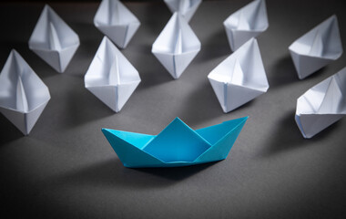 Blue and white paper boats. Business concept