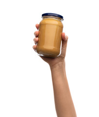 food and healthy lifestyle concept - hand holding jar with peanut butter isolated on white...