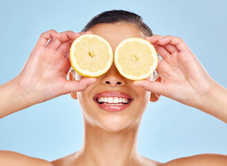 I love giving my skin a boost with organic ingredients. Studio shot of an attractive young woman posing with lemon against a blue background.