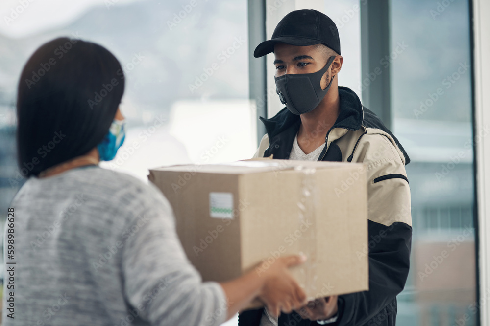 Canvas Prints Safety is first order of the day. a masked young woman receiving a delivery at home.