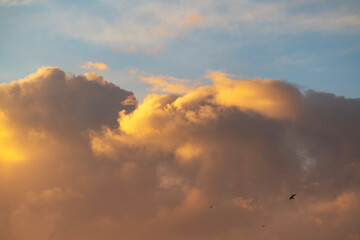 Fototapeta na wymiar Beautiful bright orange huge clouds on the sunset sky .Sky with clouds background.