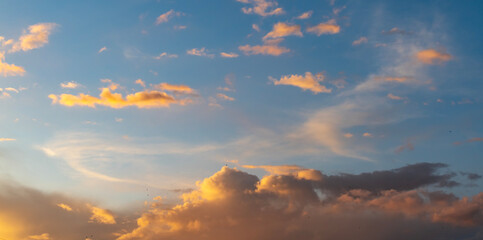 Naklejka na ściany i meble Beautiful bright summer sunset sky with clouds. Sunset sky clouds background.