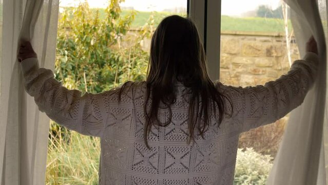 Woman opening curtains in room to summer day  Generative AI