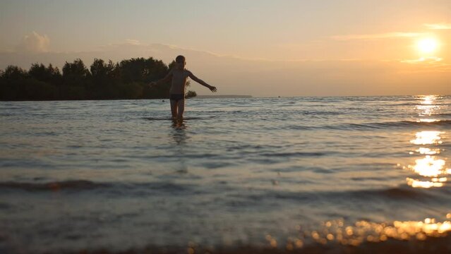 Boy having fun in sea waves on a summer day. Creative. Hot summer day during vacation. Generative AI