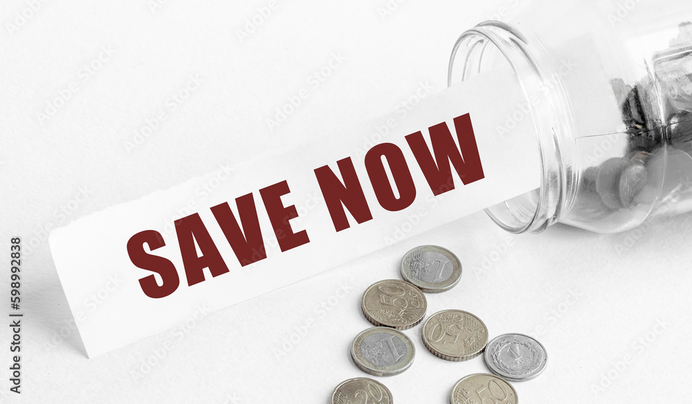 Poster paper with the text save now in a glass jar on a background of coins