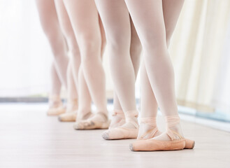 Ready for the performance of a lifetime. a group of ballerina dancers practicing a routine in their pointe shoes. - obrazy, fototapety, plakaty