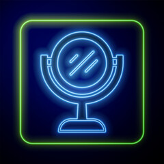 Glowing neon Hand mirror icon isolated on blue background. Vector