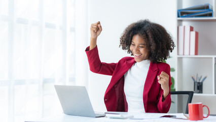 Businesswoman raising her hand in congratulation with document and laptop computer