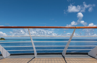 Cruise ship railing with sea view.