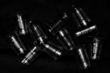 disposable plastic cup  with side light , close up in black background.