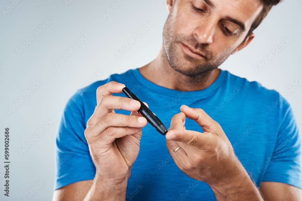 Aufkleber quick and easy. studio shot of a carefree young man taking a blood sample from a syringe out of his 