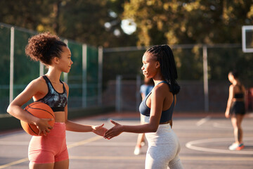Good luck. Low angle shot of a diverse group of friends huddled together before playing basketball during the day.
