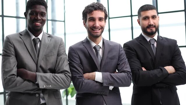 three businessmen crossing their arms looking at camera