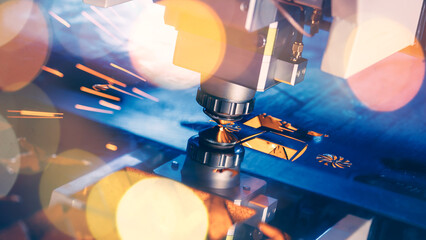 Blue color Laser CNC cut of metal with light spark, technology modern industrial banner background