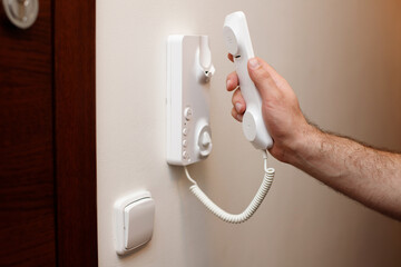 Man answering intercom to open doors