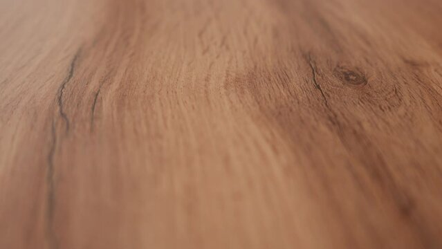Close up texture of wooden table top with natural pattern. Part of the video is out of focus. High quality 4k footage Generative AI
