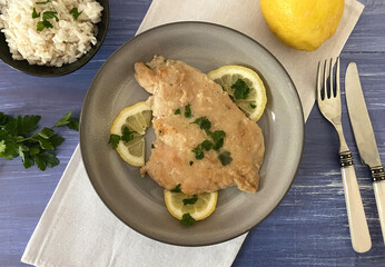 Italian Art scaloppine al limone. Also known as chicken escalope with lemon and sauce.