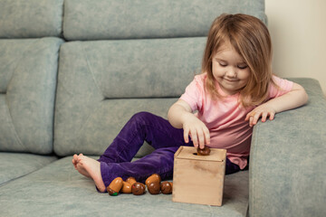 Little cute girl playing educational toys in her room