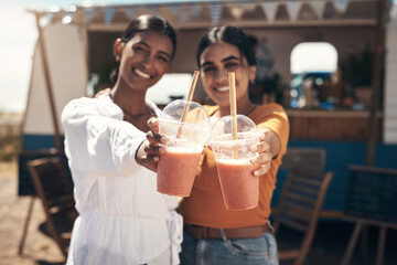 Spend time with those you love. two friends enjoying smoothies together.