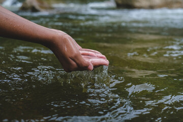 Palm hands with fresh clean water from the river. Nature water drop, environmental and freshness concept