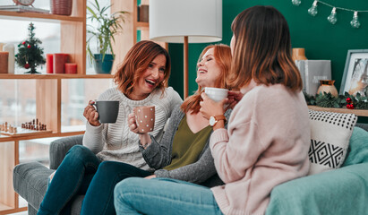 The gift of friendship. three attractive women having a coffee on the sofa together at home.
