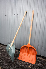 Two large shovels are waiting for the start of work on the gravel near the metal trailer. An image...