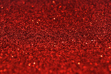 Red de focused sparkle glitter background with golden particles close up